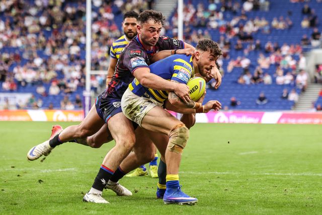 Matty Ashton of Warrington Wolves is tackled by Umyla Hanley of Leigh Leopards during the Betfred Super League Magic Weekend match Leigh Leopards vs Warrington Wolves at Leigh Sports Village, Leigh, United Kingdom on 04 July 2026

(Photo by Alfie Cosgrove/News Images)