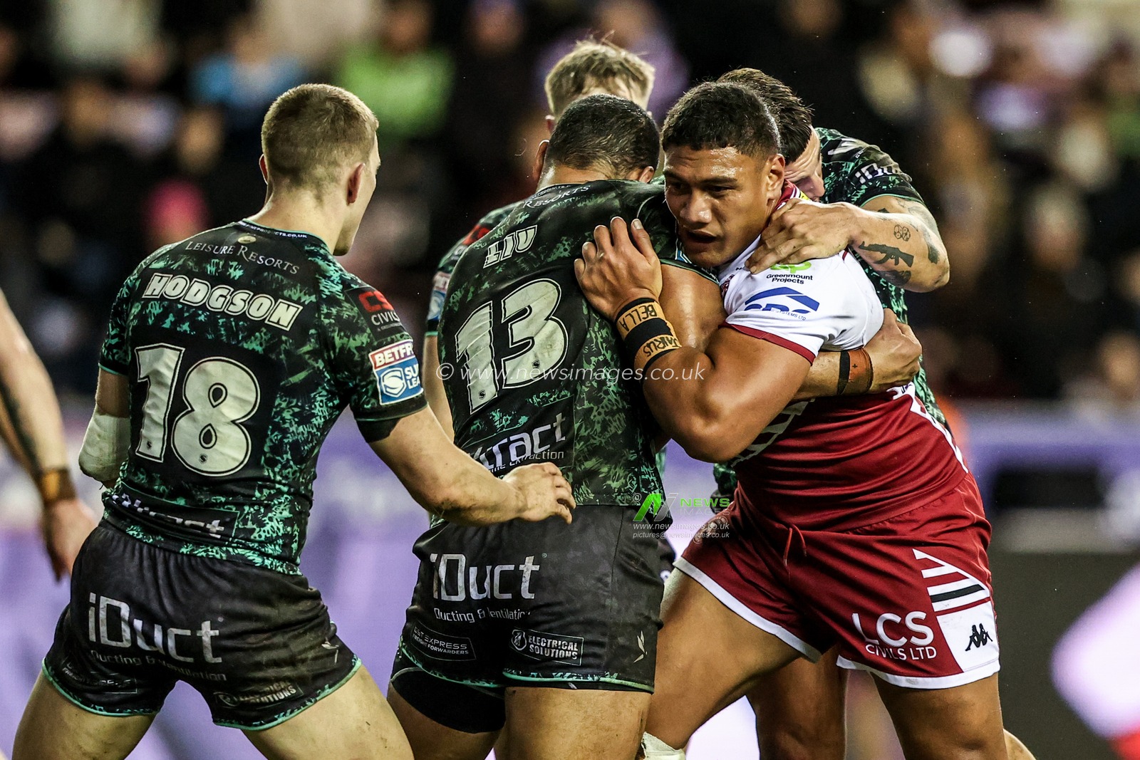 Patrick Mago of Wigan Warriors is tackled by Isaac Liu of Leigh Leopards during the Betfred Super League match Wigan Warriors vs Leigh Leopards at The Brick Community Stadium, Wigan, United Kingdom on 26 February 2026

(Photo by Alfie Cosgrove/News Images)