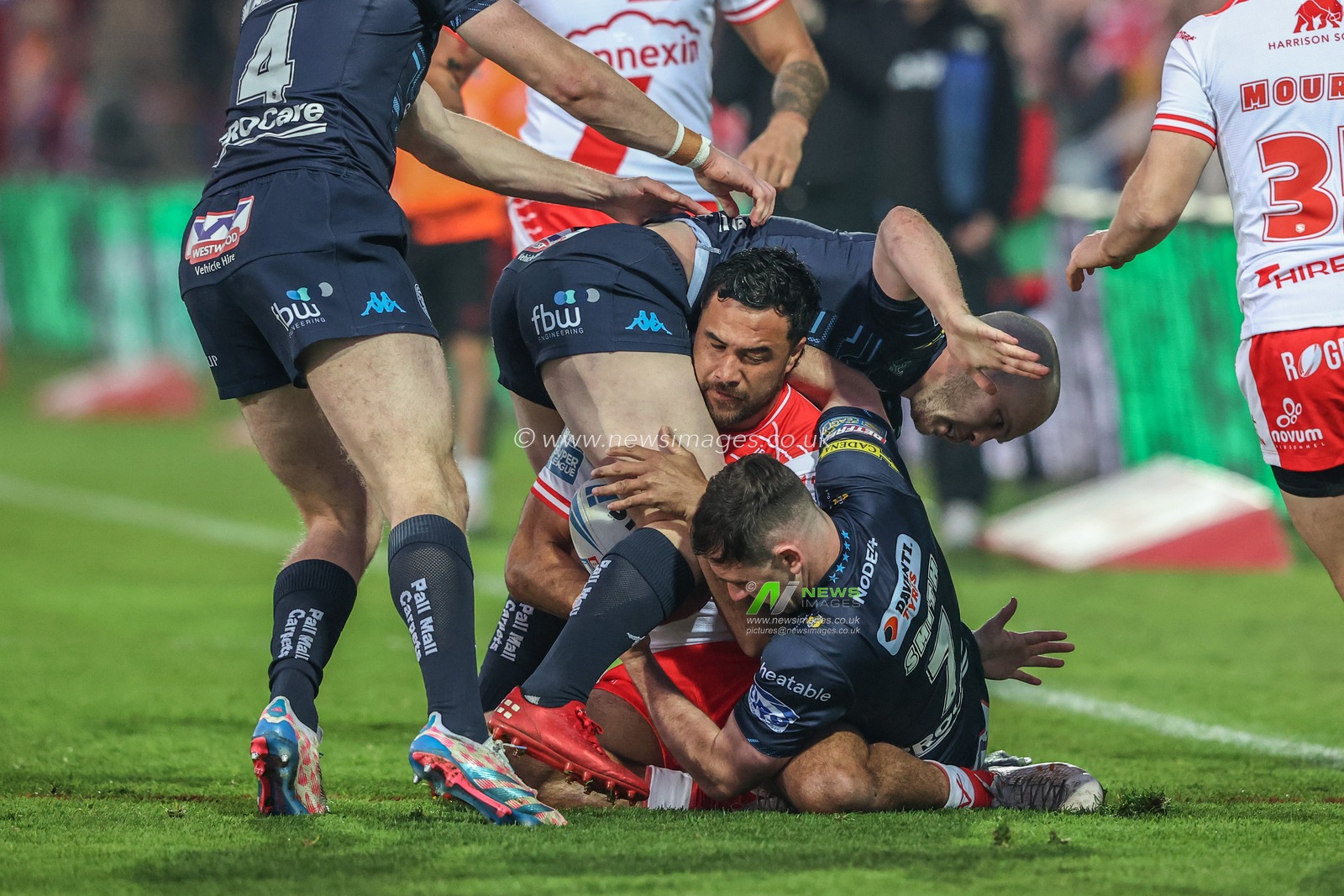 Peta Hiku of Hull KR is tackled by Liam Marshall of Wigan Warriors and Harry Smith of Wigan Warriors during the Betfred Super League Round 7 match Hull KR vs Wigan Warriors at Sewell Group Craven Park, Kingston upon Hull, United Kingdom, 11th April 2025

(Photo by Alfie Cosgrove/News Images)