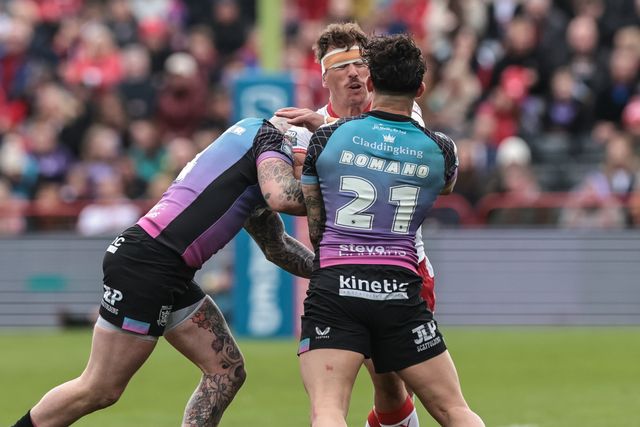 Jai Whitbread of Hull KR is tackled by Zak Hardaker of Hull F.C. and Arthur Romano of Hull F.C. during the Betfred Super League round 7 match Hull KR vs Hull FC at Sewell Group Craven Park, Hull, United Kingdom on 03 April 2026

(Photo by Mark Cosgrove/News Images)