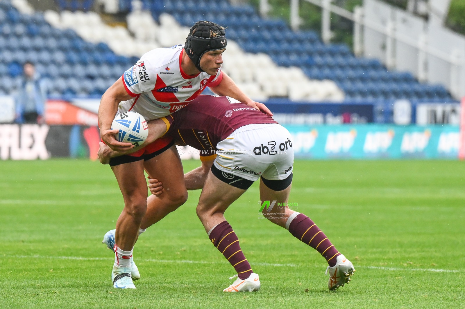 Jonny Lomax of St. Helens is tackled by Adam Clune of Huddersfield Giants during the Betfred Super League Round 24 match Huddersfield Giants vs St Helens at John Smith's Stadium, Huddersfield, United Kingdom, 1st September 2024

(Photo by Craig Thomas/News Images)