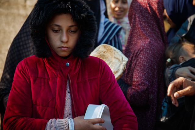 Palestinians try to get a free meal (from a charity restaurant) in a temporary displacement camp after the decision to close the American World Kitchen for the second day in a row, which exacerbated the plight of displaced Palestinians in the southern Gaza Strip.(Photo: Mohammed Skaik/News Images)