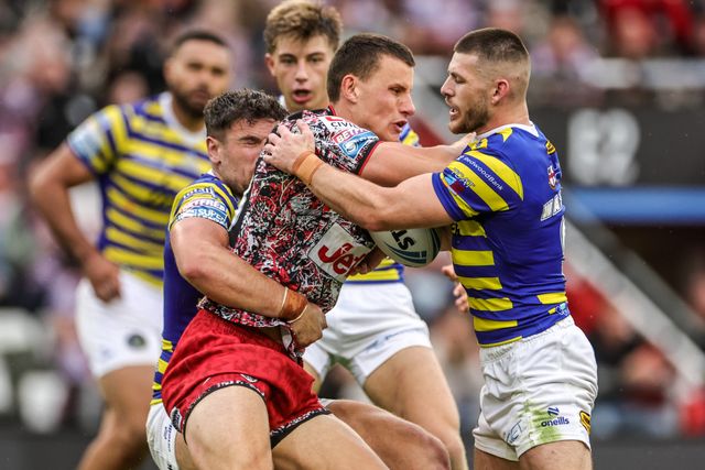 Innes Senior of Leigh Leopards is tackled by Danny Walker of Warrington Wolves and Joe Philbin of Warrington Wolves during the Betfred Super League round 20 match Leigh Leopards vs Warrington Wolves at Leigh Sports Village, Leigh, United Kingdom on 25 July 2026

(Photo by Alfie Cosgrove/News Images)