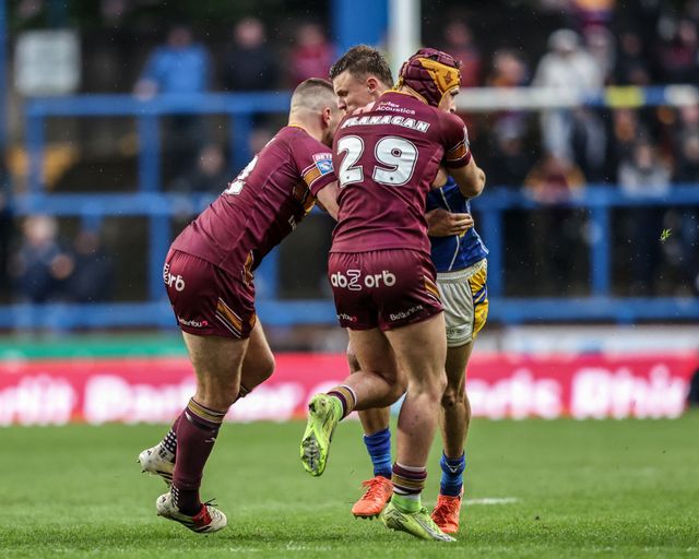 Ash Handley of Leeds Rhinos is tackled by Sam Hewitt of Huddersfield Giants and George Flanagan  of Huddersfield Giants during the Betfred Super League Round 8 match Leeds Rhinos vs Huddersfield Giants at Headingley Stadium, Leeds, United Kingdom, 18th April 2025

(Photo by Alfie Cosgrove/News Images)