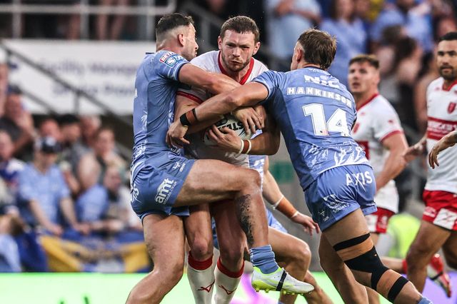 James Batchelor of Hull KR is tackled by Chris Hankinson of Leeds Rhinos and Jake Connor of Leeds Rhinos during the Betfred Super League round 16 match Leeds Rhinos vs Hull KR at AMT Headingley Stadium, Leeds, United Kingdom on 26 June 2026

(Photo by Alfie Cosgrove/News Images)