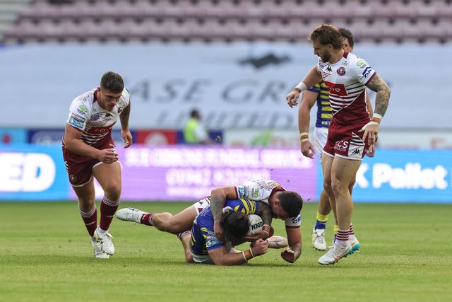 James Bentley of Warrington Wolves is tackled by Oliver Partington of Wigan Warriors during the Betfred Super League round 18 match Wigan Warriors vs Warrington Wolves at The Brick Community Stadium, Wigan, United Kingdom on 10 July 2026

(Photo by Mark Cosgrove/News Images)