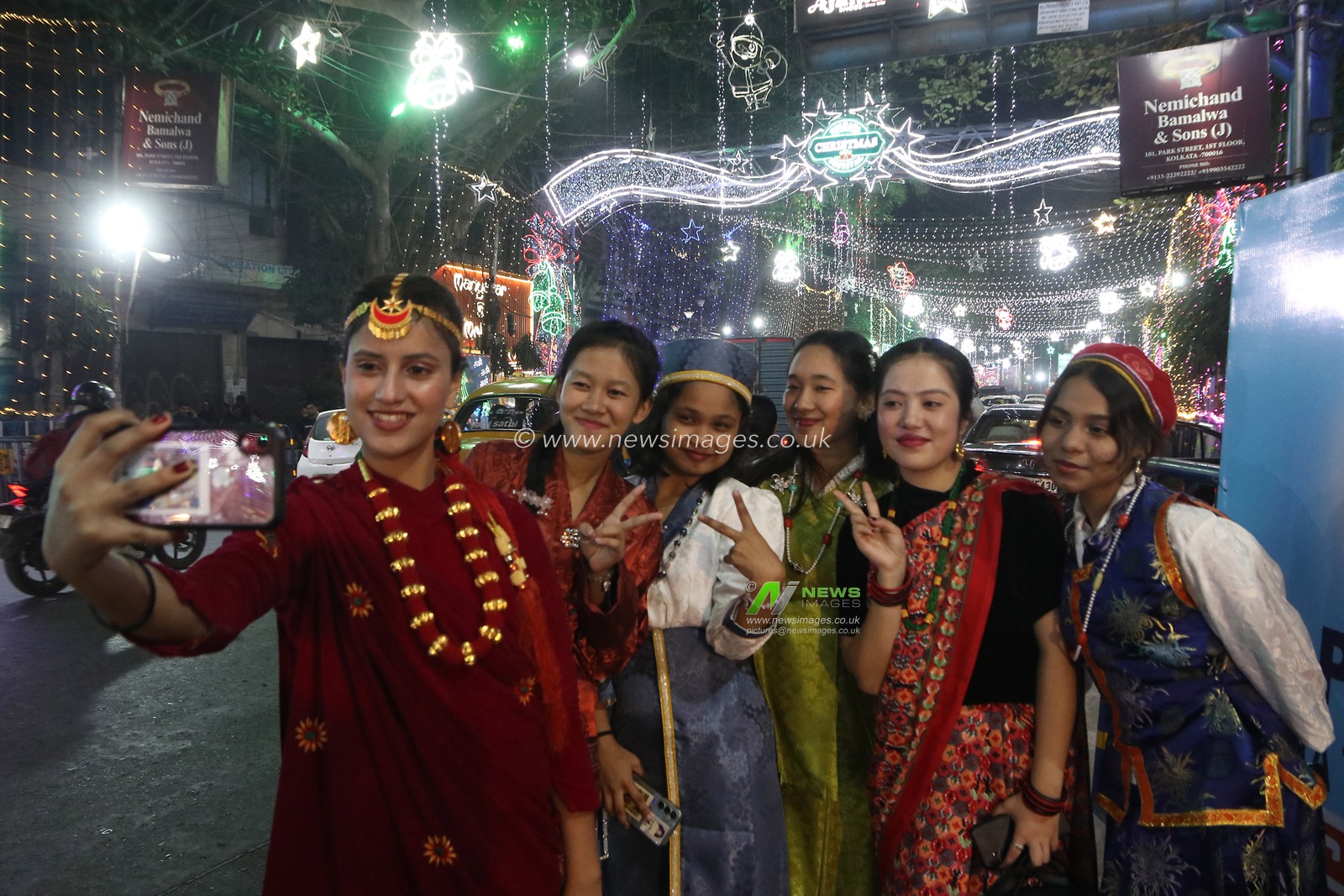 A group of Indian women take selfie on a mobile phone in a street decorated ahead of Christmas in Kolkata, India, 19 December 2024,Pictures by Debajyoti Chakraborty.(Photo: Debajyoti Chakraborty/News Images)