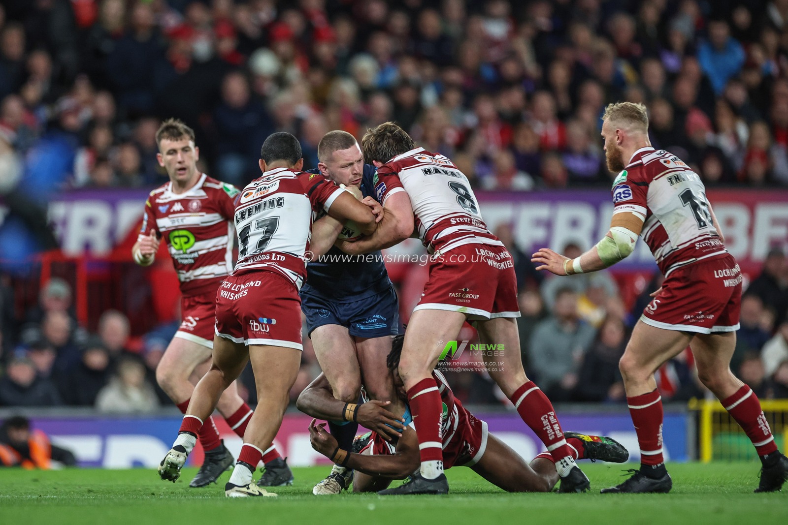 James Batchelor of Hull KR is tackled by Junior Nsemba of Wigan Warriors, Kruise Leeming of Wigan Warriors and Ethan Havard of Wigan Warriors during the Betfred Super League Grand Final match Wigan Warriors vs Hull KR at Old Trafford, Manchester, United Kingdom, 12th October 2024

(Photo by Mark Cosgrove/News Images)