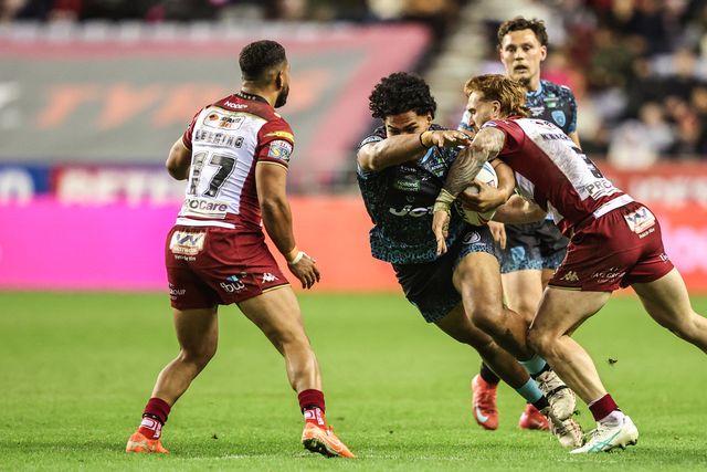 Alec Tuitavake of Leigh Leopards is tackled by Adam Keighran of Wigan Warriors during the Betfred Super League Semi Final 1 match Wigan Warriors vs Leigh Leopards at The Brick Community Stadium, Wigan, United Kingdom, 3rd October 2025

(Photo by Alfie Cosgrove/News Images)