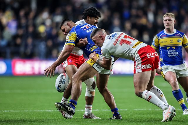 Ryan Hall of Leeds Rhinos drops the ball under pressure from Curtis Sironen of St. Helens during the Betfred Super League play-off Eliminator 1 match Leeds Rhinos vs St Helens at Headingley Stadium, Leeds, United Kingdom, 27th September 2025

(Photo by Alfie Cosgrove/News Images)