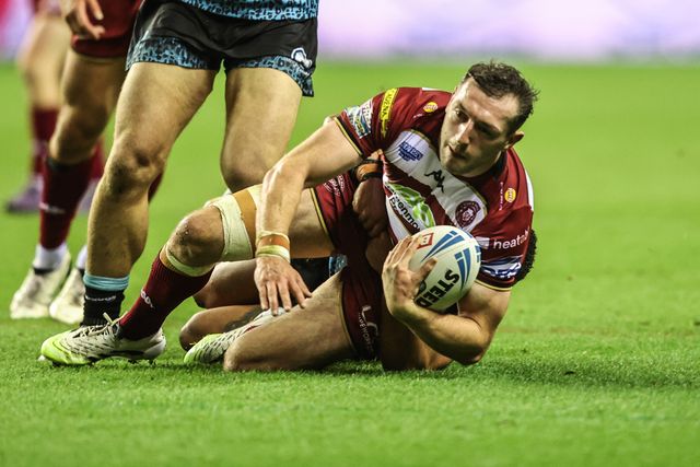 Jake Wardle of Wigan Warriors is tackled by Umyla Hanley of Leigh Leopards during the Betfred Super League Semi Final 1 match Wigan Warriors vs Leigh Leopards at The Brick Community Stadium, Wigan, United Kingdom, 3rd October 2025

(Photo by Alfie Cosgrove/News Images)