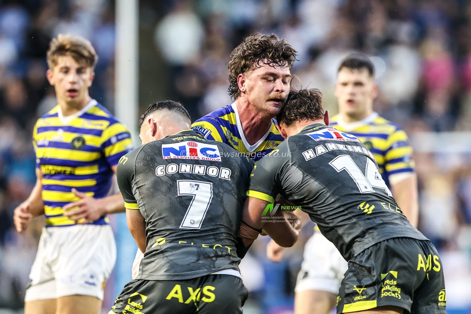 Jordy Crowther of Warrington Wolves is tackled by Jake Connor of Leeds Rhinos and Chris Hankinson of Leeds Rhinos during the Betfred Super League round 15 match Warrington Wolves vs Leeds Rhinos at The Halliwell Jones Stadium, Warrington, United Kingdom on 18 June 2026

(Photo by Alfie Cosgrove/News Images)