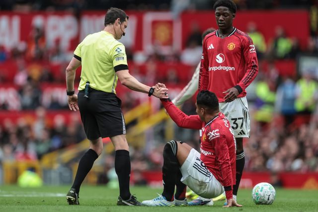 Referee Darren England helps Casemiro of Manchester United up off the floor during the Premier League match Manchester United vs Liverpool at Old Trafford, Manchester, United Kingdom on 03 May 2026

(Photo by Mark Cosgrove/News Images)