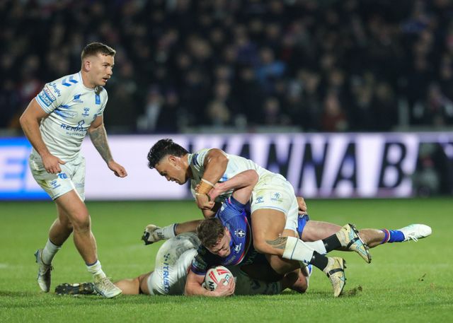 Jake Trueman of Wakefield Trinity is tackled by Mathieu Jussaume of Toulouse Olympique and Reubenn Rennie of Toulouse Olympique during the Betfred Super League Round 1 match Wakefield Trinity vs Toulouse Olympique at DIY Kitchens Stadium, Wakefield, United Kingdom on 14 February 2026

(Photo by Richard Bierton/News Images)