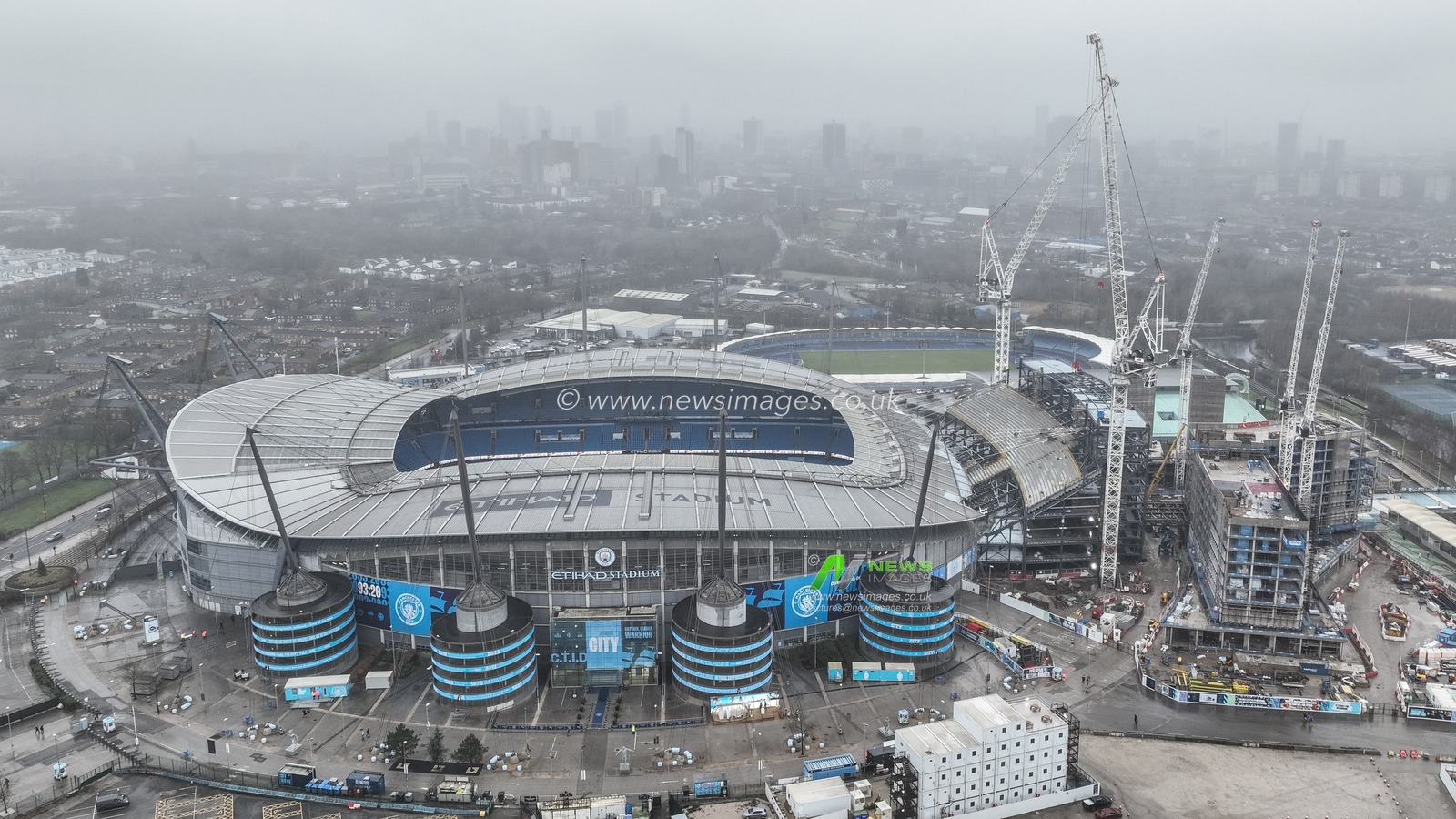 An aerial view of the Etihad Stadium and a misty City of Manchester in the background ahead of the Premier League match Manchester City vs Manchester United at Etihad Stadium, Manchester, United Kingdom, 15th December 2024

(Photo by Mark Cosgrove/News Images)