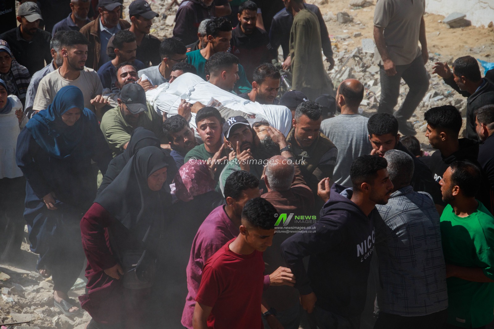 Families bid farewell to their sons killed in today's Israeli massacre at the Al-Wehda Street market in western Gaza City, which left 40 dead and a large number of injuries, including children and women.(Photo: Mohammed Skaik/News Images)