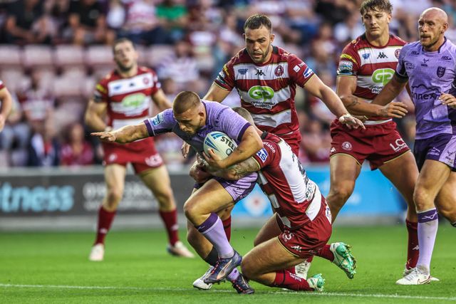 Mikey Lewis of Hull KR is tackled during the Betfred Super League round 22 match Wigan Warriors vs Hull KR at The Brick Community Stadium, Wigan, United Kingdom, 15th August 2025

(Photo by Alfie Cosgrove/News Images)