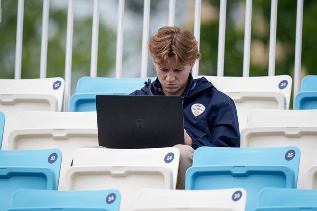 A person works while sitting in the stands during the County Championship Division Two Derbyshire vs Northamptonshire day four match at The Central Co-Op County Ground, Derby, United Kingdom on 11 May 2026

(Photo by Maynard Manyowa/News Images)