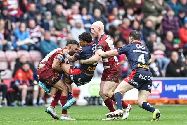 Tristan Sailor of St. Helens is tackled by Bevan French of Wigan Warriors and Liam Farrell of Wigan Warriors during the Betfred Super League Round 8 match Wigan Warriors vs St Helens at The Brick Community Stadium, Wigan, United Kingdom, 18th April 2025

(Photo by Mark Cosgrove/News Images)