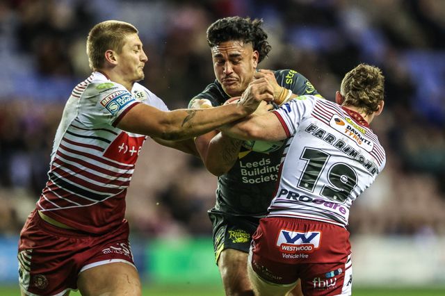 Keenan Palasia of Leeds Rhinos is tackled by Kaide Ellis of Wigan Warriors and Jack Farrimond of Wigan Warriors during the Betfred Super League round 11 match Wigan Warriors vs Leeds Rhinos at The Brick Community Stadium, Wigan, United Kingdom on 15 May 2026

(Photo by Alfie Cosgrove/News Images)