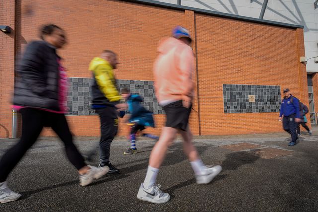 A general view shows fans walking past  the ‘our blue and amber’ memorial wall a the stadium during the Betfred Super League round 1 match Leeds Rhinos vs Warrington Wolves at AMT Headingley Stadium, Leeds, United Kingdom on 29 March 2026

(Photo by Maynard Manyowa/News Images)