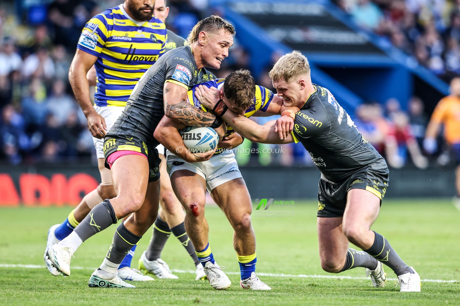 Leon Hayes of Warrington Wolves is tackled by James McDonnell of Leeds Rhinos during the Betfred Super League round 15 match Warrington Wolves vs Leeds Rhinos at The Halliwell Jones Stadium, Warrington, United Kingdom on 18 June 2026

(Photo by Alfie Cosgrove/News Images)