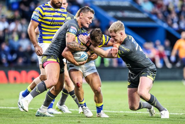 Leon Hayes of Warrington Wolves is tackled by James McDonnell of Leeds Rhinos during the Betfred Super League round 15 match Warrington Wolves vs Leeds Rhinos at The Halliwell Jones Stadium, Warrington, United Kingdom on 18 June 2026

(Photo by Alfie Cosgrove/News Images)