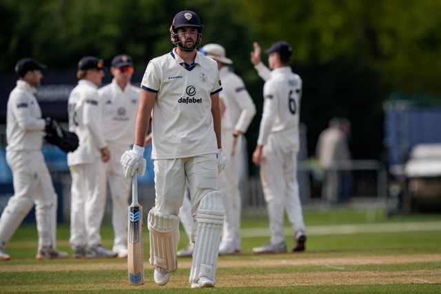 Ben Aitchison walks off after being caught by Cameron Bancroft off the bowling of Craig Miles as Gloucestershire players celebrate a wicket during the County Championship Division Two Derbyshire v Gloucestershire at The Central Co-Op County Ground, Derby, United Kingdom on 26 April 2026

(Photo by Maynard Manyowa/News Images)