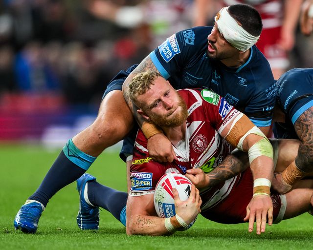 Luke Thompson of Wigan Warriors is tackled by Elliot Minchella of Hull KR during the Betfred Super League Grand Final match Wigan Warriors vs Hull KR at Old Trafford, Manchester, United Kingdom, 12th October 2024

(Photo by Craig Thomas/News Images)