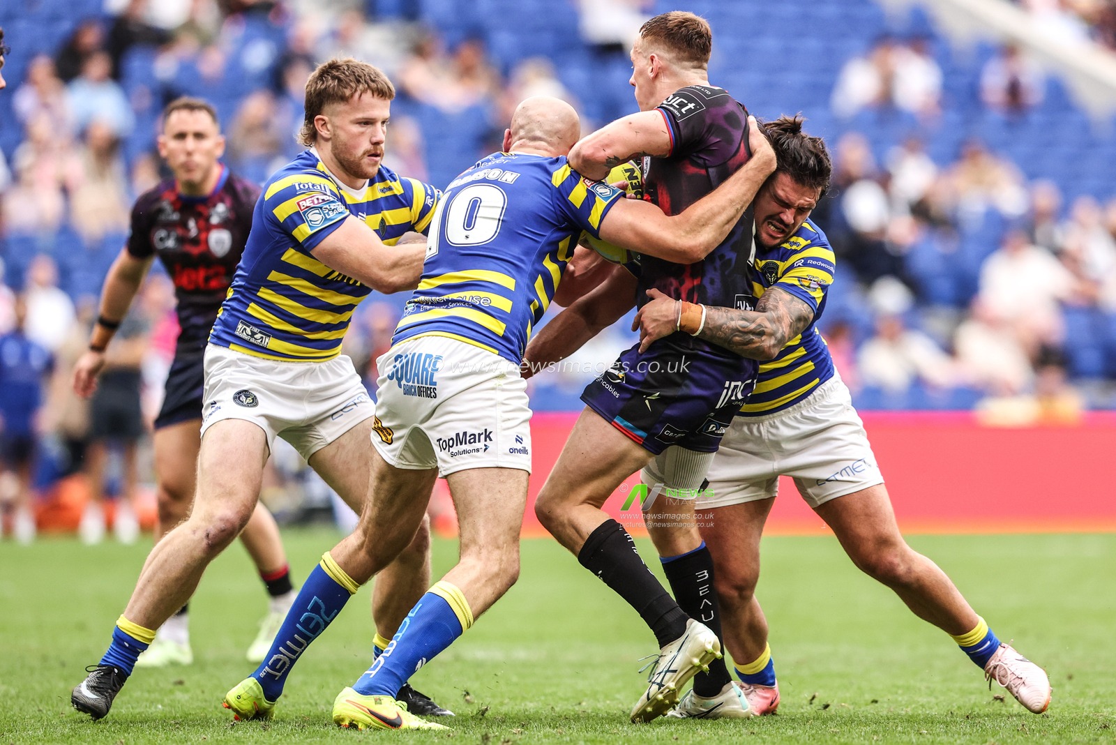 Frankie Halton of Leigh Leopards is tackled by James Harrison of Warrington Wolves and Luke Thomas of Warrington Wolves during the Betfred Super League Magic Weekend match Leigh Leopards vs Warrington Wolves at Leigh Sports Village, Leigh, United Kingdom on 04 July 2026

(Photo by Alfie Cosgrove/News Images)