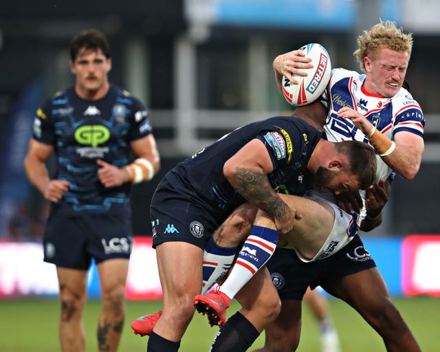 Kaide Ellis of Wigan Warriors tackles Lachlan Walmsley of Wakefield Trinity during the Betfred Super League round 15 match Wakefield Trinity vs Wigan Warriors at DIY Kitchens Stadium, Wakefield, United Kingdom, 20th June 2025

(Photo by Sam Eaden/News Images)
