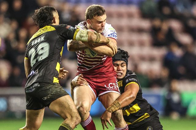 Kaide Ellis of Wigan Warriors is tackled by Xavier Va'a of York Knights and Sam Cook of York Knights during the Betfred Super League round 5 match Wigan Warriors vs York Knights at The Brick Community Stadium, Wigan, United Kingdom on 19 March 2026

(Photo by Alfie Cosgrove/News Images)