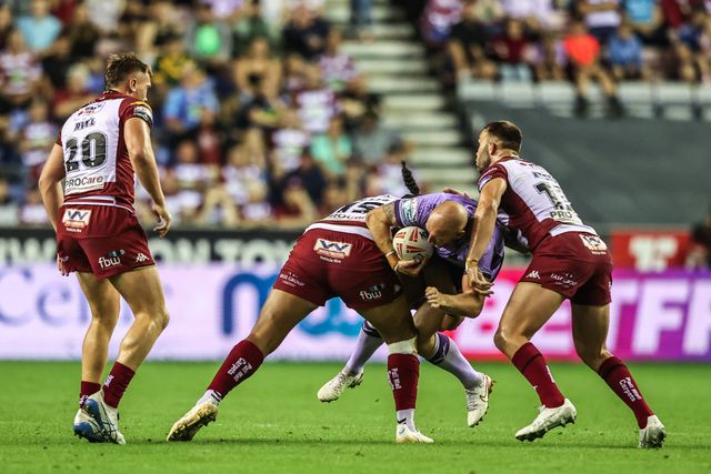 Dean Hadley of Hull KR is tackled during the Betfred Super League round 22 match Wigan Warriors vs Hull KR at The Brick Community Stadium, Wigan, United Kingdom, 15th August 2025

(Photo by Alfie Cosgrove/News Images)