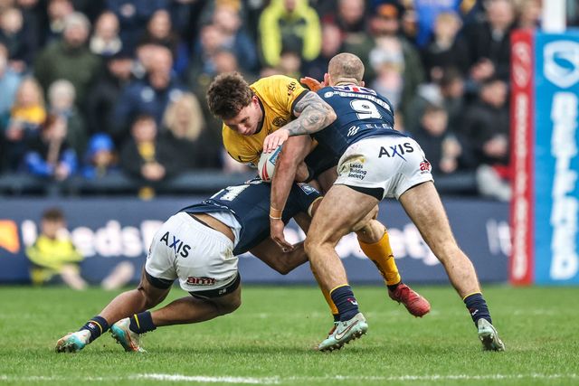George Lawler of Castleford Tigers is tackled by Kallum Watkins of Leeds Rhinos and Jarrod O'Connor of Leeds Rhinos during the Betfred Super League round 4 match Leeds Rhinos vs Castleford Tigers at AMT Headingley Stadium, Leeds, United Kingdom on 08 March 2026

(Photo by Alfie Cosgrove/News Images)