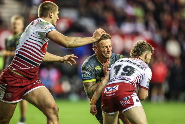 Chris Hankinson of Leeds Rhinos is tackled by Jack Farrimond of Wigan Warriors during the Betfred Super League round 11 match Wigan Warriors vs Leeds Rhinos at The Brick Community Stadium, Wigan, United Kingdom on 15 May 2026

(Photo by Alfie Cosgrove/News Images)