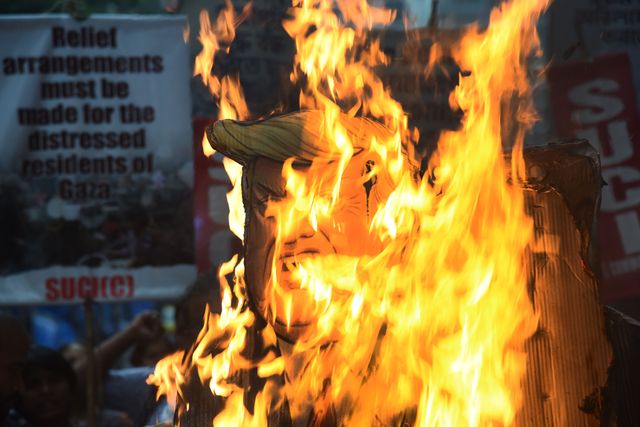 Activists of Social Unity Center of India (SUCI) hold placards and an effigy of US President Donald Trump and Israel's Prime Minister Benjamin Netanyahu during a protest against Western policy in the Israel-Hamas conflict, near US Embassy in Kolkata, Eastern India, 07 October 2025.Photo by Debajyoti Chakraborty.(Photo: Debajyoti Chakraborty/News Images)