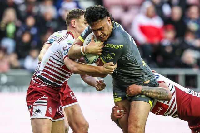 Keenan Palasia of Leeds Rhinos is tackled by Oliver Partington of Wigan Warriors during the Betfred Super League round 11 match Wigan Warriors vs Leeds Rhinos at The Brick Community Stadium, Wigan, United Kingdom on 15 May 2026

(Photo by Alfie Cosgrove/News Images)
