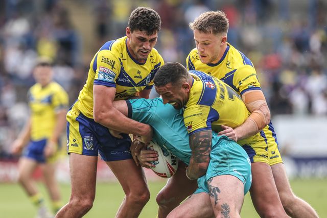 Jake Bibby of Huddersfield Giants is tackled by Sam Stone of Warrington Wolves and Paul Vaughan of Warrington Wolves during the Betfred Super League round 15 match Warrington Wolves vs Huddersfield Giants at Halliwell Jones Stadium, Warrington, United Kingdom, 21st June 2025

(Photo by Alfie Cosgrove/News Images)