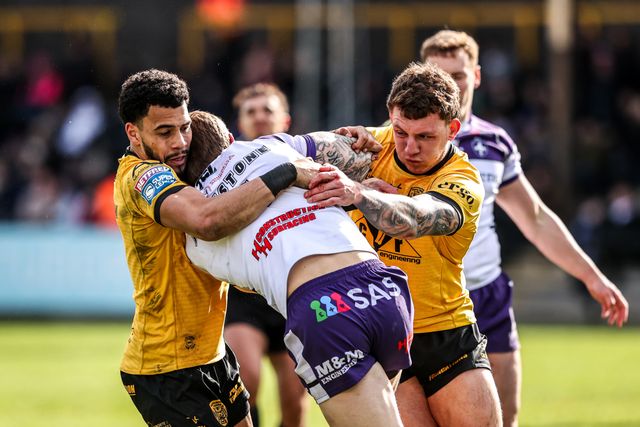 Tom Johnstone of Wakefield Trinity is tackled by Jordan Lane of Castleford Tigers and Darnell McIntosh of Castleford Tigers during the Betfred Super League round 7 match Castleford Tigers vs Wakefield Trinity at OneBore Stadium, Castleford, Untied Kingdom on 05 April 2026

(Photo by Alfie Cosgrove/News Images)