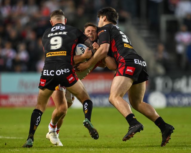 Tom Davies of Catalan Dragons is tackled by Daryl Clark of St. Helens and Noah Stephens of St. Helens  during the Betfred Super League Round 13 match St Helens vs Catalans Dragons at Totally Wicked Stadium, St Helens, United Kingdom, 31st May 2024

(Photo by Craig Thomas/News Images)