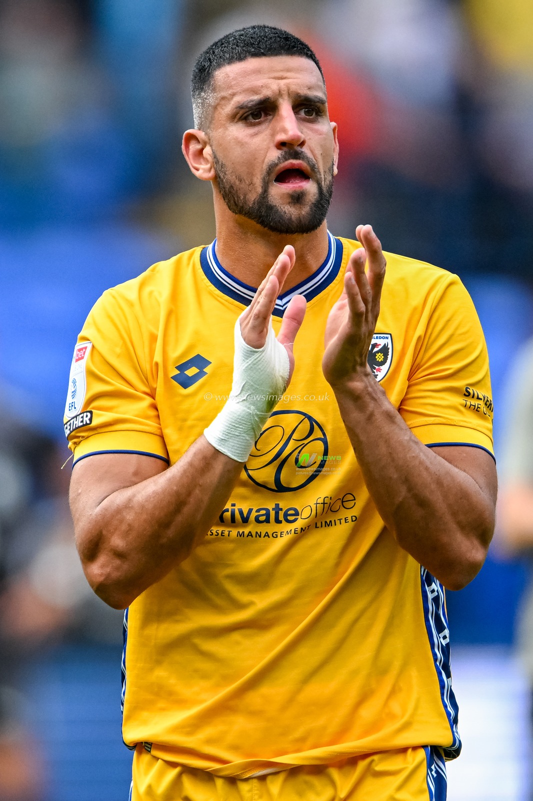 Omar Bugiel of AFC Wimbledon acknowledges the travelling supporters during the Sky Bet League 1 match Bolton Wanderers vs AFC Wimbledon at Toughsheet Community Stadium, Bolton, United Kingdom, 6th September 2025

(Photo by Adam Gee/News Images)