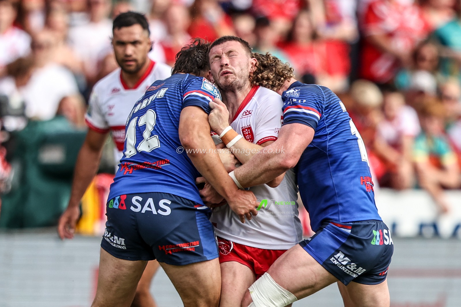 James Batchelor of Hull KR is tackled by Matty Storton of Wakefield Trinity and Ky Rodwell of Wakefield Trinity during the Betfred Super League round 18 match Hull KR vs Wakefield Trinity at Sewell Group Craven Park, Hull, United Kingdom on 11 July 2026

(Photo by Alfie Cosgrove/News Images)