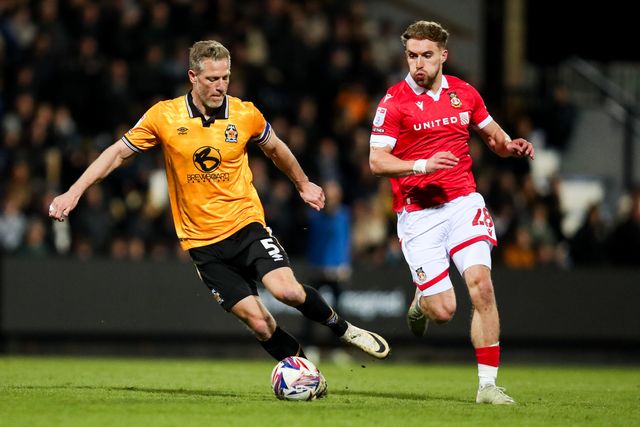 Michael Morrison of Cambridge United is put under pressure by Sam Smith of Wrexham AFC during the Sky Bet League 1 match Cambridge United vs Wrexham at Abbey Stadium, Cambridge, United Kingdom, 1st April 2025

(Photo by Izzy Poles/News Images)