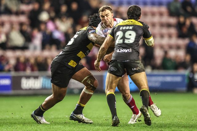 Kaide Ellis of Wigan Warriors is tackled by Xavier Va'a of York Knights and Sam Cook of York Knights during the Betfred Super League round 5 match Wigan Warriors vs York Knights at The Brick Community Stadium, Wigan, United Kingdom on 19 March 2026

(Photo by Alfie Cosgrove/News Images)