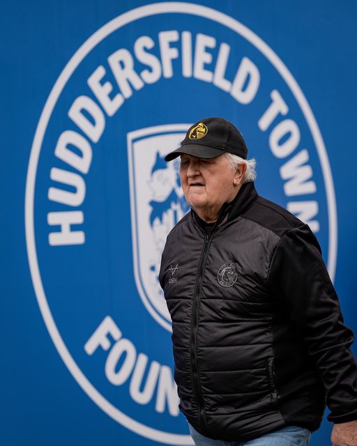 Knights fan walk past a Huddersfield Town FC badge outside the stadium during the Betfred Super League round 7 match Huddersfield Giants vs York Knights at Accu Stadium, Huddersfield, United Kingdom on 04 April 2026

(Photo by Maynard Manyowa/News Images)