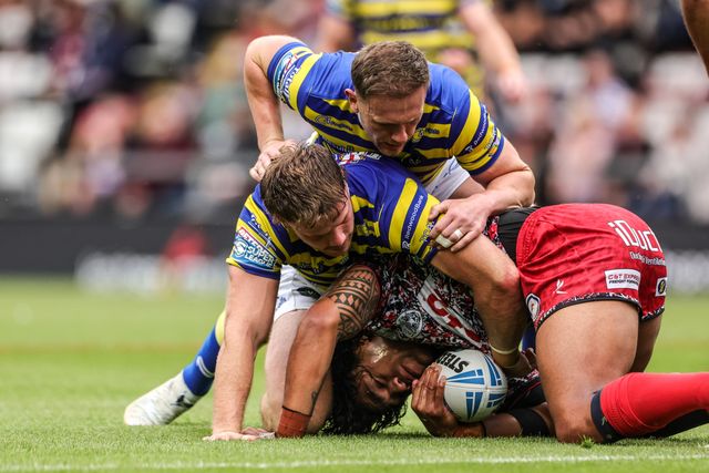 Joe Ofahengaue of Leigh Leopards is tackled by Luke Thomas of Warrington Wolves and Ben Currie of Warrington Wolves during the Betfred Super League round 20 match Leigh Leopards vs Warrington Wolves at Leigh Sports Village, Leigh, United Kingdom on 25 July 2026

(Photo by Alfie Cosgrove/News Images)
