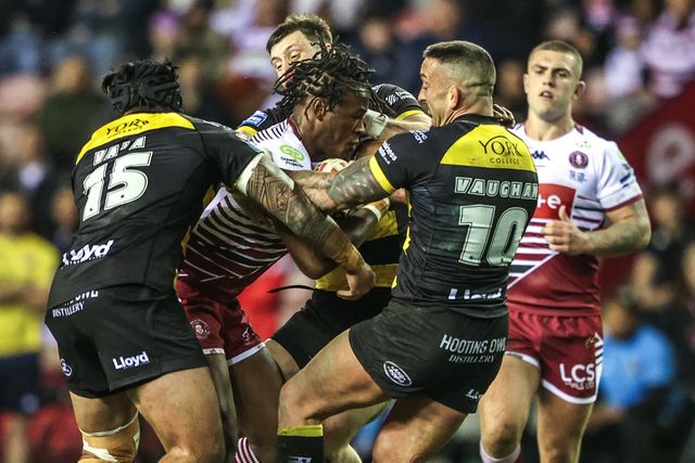Junior Nsemba of Wigan Warriors is tackled by Paul Vaughan of York Knights and Xavier Va'a of York Knights during the Betfred Super League round 5 match Wigan Warriors vs York Knights at The Brick Community Stadium, Wigan, United Kingdom on 19 March 2026

(Photo by Alfie Cosgrove/News Images)