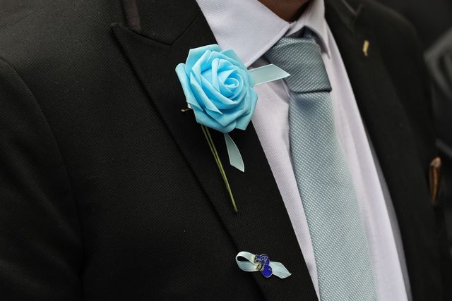 A mourner wearing a City blue rose and a boxing glove ribbon during Ricky Hatton' Funeral at Manchester Cathedral, Manchester, United Kingdom, 10th October 2025

(Photo by Mark Cosgrove/News Images)