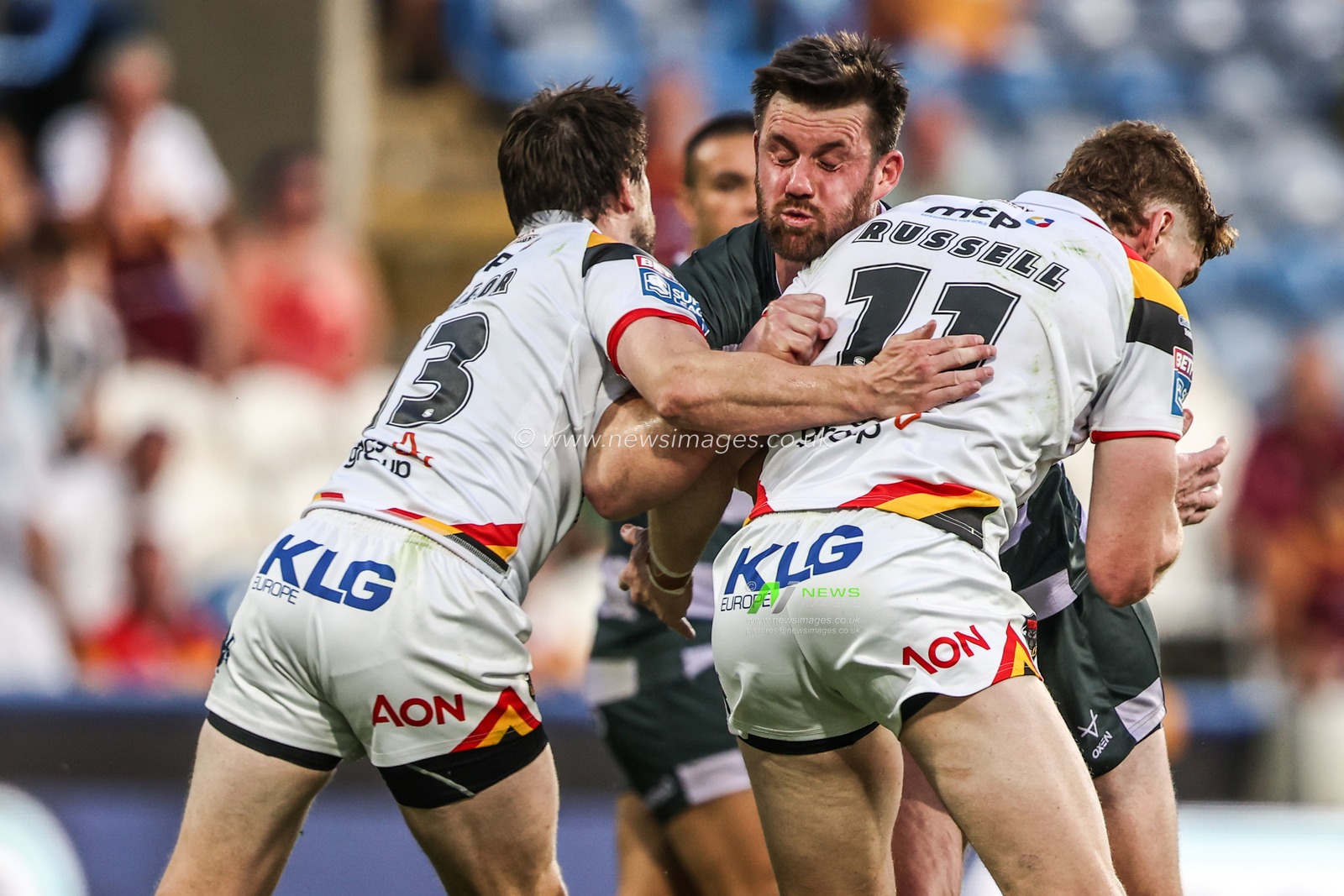 Joe Greenwood of Huddersfield Giants is tackled by Joe Mellor of Bradford Bulls and Dan Russell of Bradford Bulls during the Betfred Super League round 18 match Huddersfield Giants vs Bradford Bulls at Accu Stadium, Huddersfield, United Kingdom on 10 July 2026

(Photo by Alfie Cosgrove/News Images)