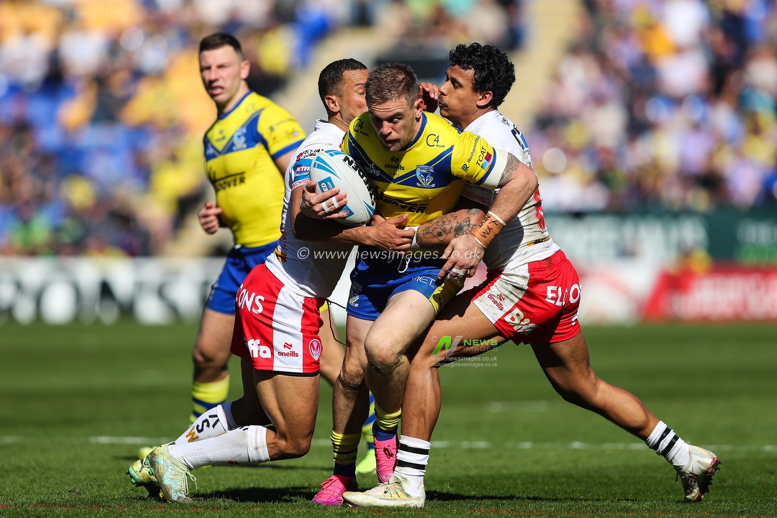 Moses Mbye of St. Helens and Tristan Sailor of St. Helens tackle Matt Dufty of Warrington Wolves during the Betfred Challenge Cup Quarter Final match Warrington Wolves vs St Helens at Halliwell Jones Stadium, Warrington, United Kingdom, 5th April 2025

(Photo by Gareth Evans/News Images)